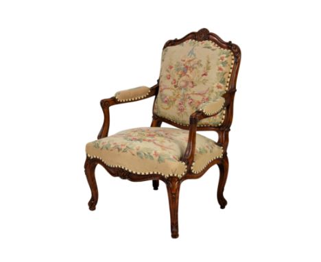 A Louis XV style carved beech wood fauteuil, late 20th century, the padded, squared cartouche back with foliate carved frame 