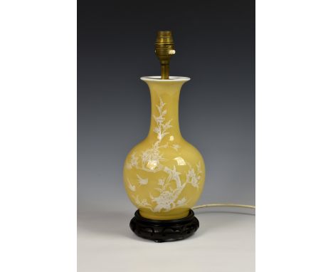 A Chinese yellow glazed porcelain bottle vase, probably early 20th century, later converted to a lamp, white slip decorated w