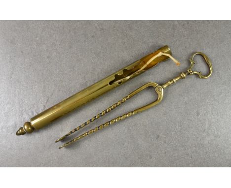 A late 18th or early 19th century brass wall-mounted cylindrical taper/spill holder, 12¼in. (31.2cm.) high, together with a p
