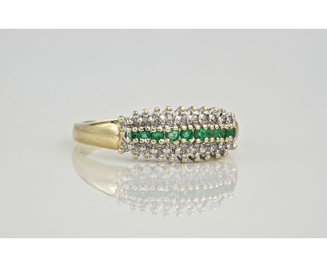 A 9ct emerald and diamond three row ring, featuring 9 round cut emeralds to the centre of the band with 11 round cut diamonds