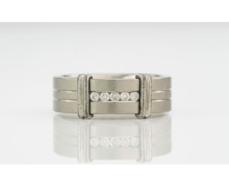 A titanium and diamond ring, featuring five round cut diamonds to the centre of the band. Ring size S. 