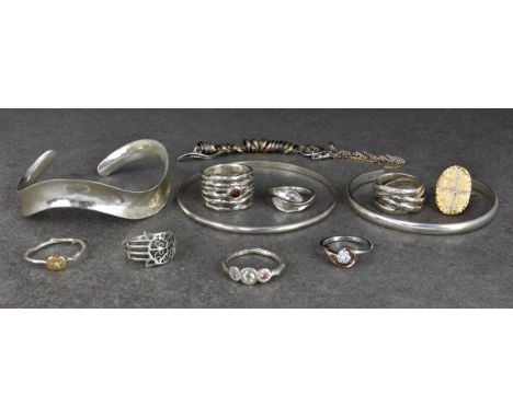 A collection of silver jewellery, to include 4 bracelets and 8 rings, the rings of various contemporary designs, the bangles 