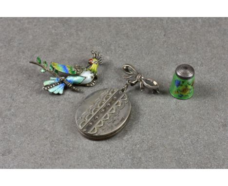 A Sterling silver enamel brooch depicting a bird of paradise, together with a enamel and silver thimble depicting flowers on 