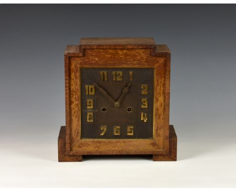 A 1930s Art Deco oak cased mantel clock, the eight day Hamburg American Clock Co. movement striking the hours and half hour o