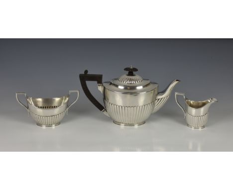 A Victorian silver three piece bachelor's tea service, Elkington &amp; Co., Birmingham 1882 / 83, comprising a teapot, milk j