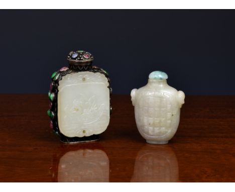 A Chinese pale jade snuff bottle, of flattened vase form with carved twin mask ring handles, with carved panels to either sid