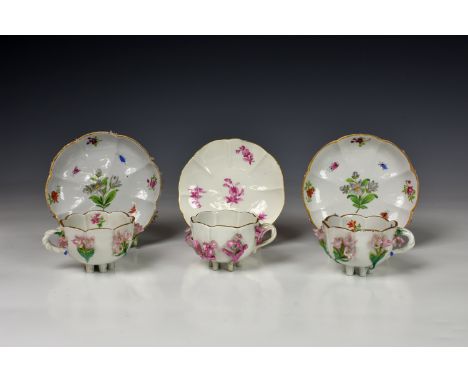 A pair of Meissen porcelain floral encrusted cabinet cups and saucers, early 'AR' mark but probably late 19th century, the fl