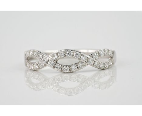 A 9ct white gold and diamond twist ring, set with pavé diamonds totalling approximately 0.30ct. Ring size N1/2. 