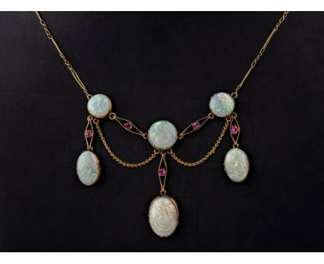 A vintage 9ct gold, opal and ruby fringe necklace, featuring 6 oval and round opals and 5 round cut rubies. 