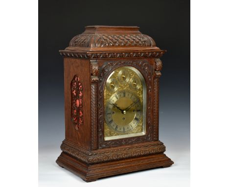 An English oak triple fusee musical boardroom clock, the 7¼in. silvered Roman chapter ring on an arched plate with engraved s