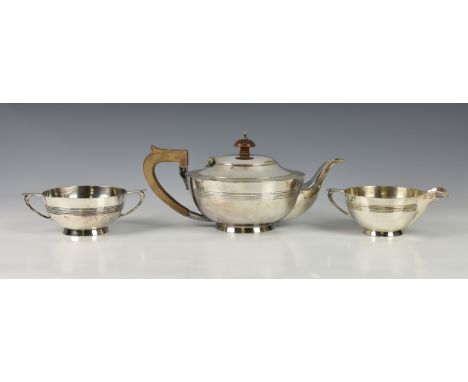 A Walker &amp; Hall silver plated three piece tea service, early to mid 20th century, of circular squat form, having ribbed d