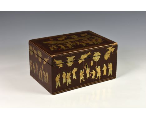 A Chinese export red lacquered tea caddy, early 19th century, the exterior decorated in gilt and iron red with scenes of a dr