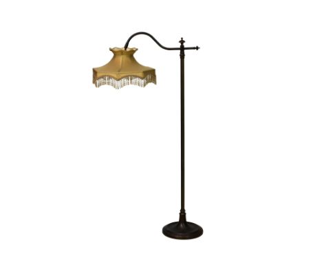 A modern bronzed reading lamp, with glass bead fringed silk shade, 46¾in. (118.8cm.) high. 
