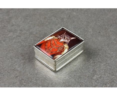 A modern miniature pill box with enamel lid depicting a pictorial image of a cat, stamped sterling to inner, 1¼in. (3.2cm.) l