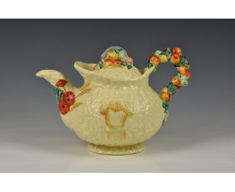 An early 20th century Clarice Cliff ' Celtic Harvest ware' teapot, embossed fruit and wheat sheaf decoration, marked to base,