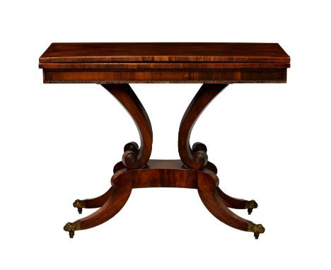 A late Regency rectangular rosewood card table, the well figured, cross banded foldover top over a panelled frieze with bead 