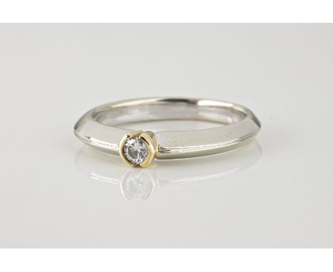 A 9ct yellow and white gold solitaire diamond ring, with a 0.10ct brilliant cut stone, on a bladed shank, ring size L½.  