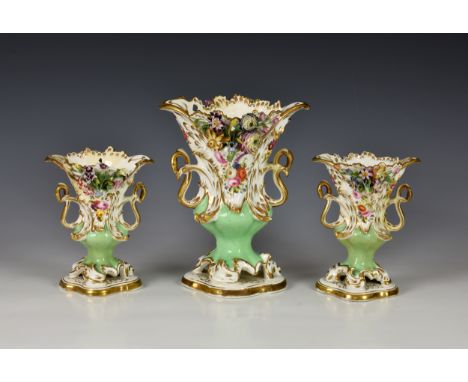 A garniture of three Coalbrookdale style vases, 19th century, encrusted and moulded with flowers, with enamel detail, the gre