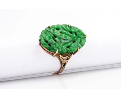 An Oriental 9ct rose gold and jade ring, the carved jade top of vibrant green colour and measuring approximately 22x15mm. Rin