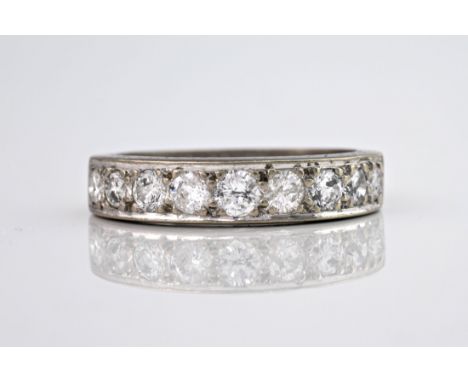 An 18ct white gold half eternity ring, the graduated brilliant cut diamonds weighing a total of approximately 0.83ct. With en