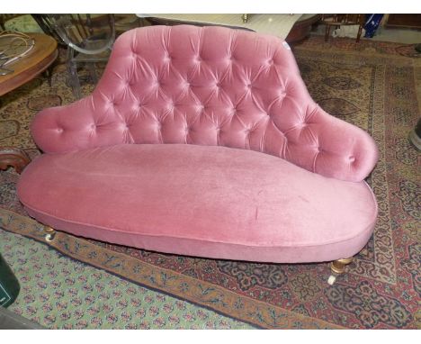 An elegant circa 1900 Sofa having buttoned back pink Dralon upholstery and standing on turned front legs terminating in white
