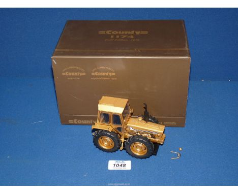 A Universal Hobbies 'County 1174 Gold Edition 1979' tractor, 1:32 scale model, boxed.