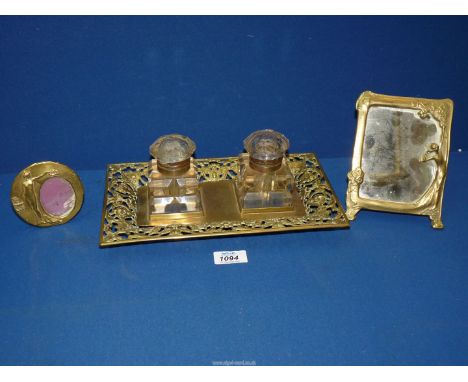 An ornate brass desk Inkwell stand with foliate scroll detail and cut glass inkwells, together with a small Art Nouveau figur