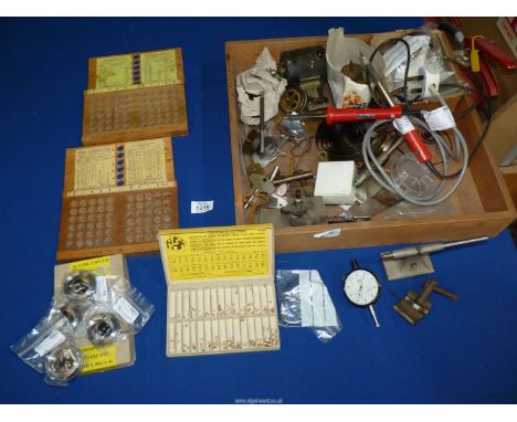 A quantity of watchmakers tools and components to include: baty dial test indicator, 2KWM bushing tool with bushes, clock key