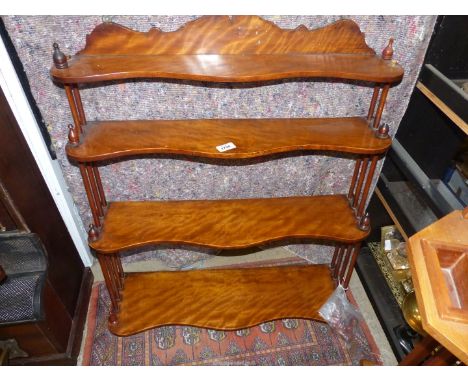 A Mahogany serpentine front four-tier wall hanging shelf unit with turned supports, 28" wide x 30" high x 8 1/2" deep (some l