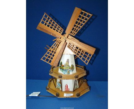 A Windmill lamp with musical box playing 'Tulips from Amsterdam', (turn sails clockwise to wind the musical box), 14 1/2" tal