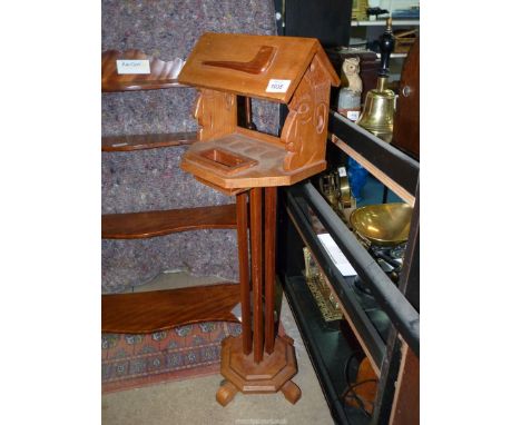 A hand-made smoker's/pipe Stand with carved faces to each side, 33" tall.