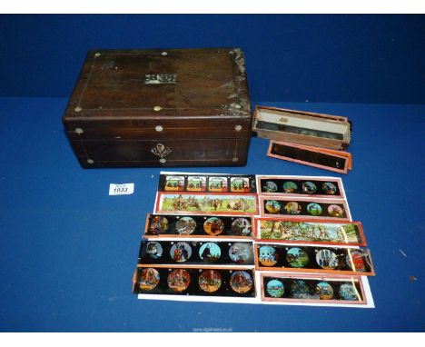 A mother of pearl inlaid Box (a/f) containing magic lantern glass slides.
