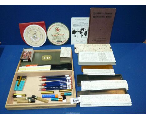 A number of slide rules, calculating tables and booklet, a box of ESSO branded propelling pencils (with spare leads and erase