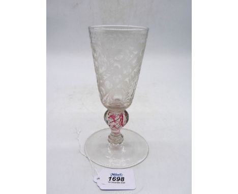 A fine German wine Goblet, mid 18th century, the bowl cut and faceted with a floral design, the stem with twisted red inclusi