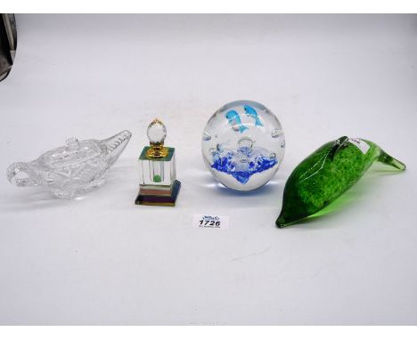 Four pieces of glass to include: dolphin paperweights, model of an old oil lamp and a perfume bottle.