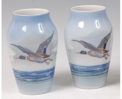 A pair of Royal Copenhagen porcelain vases, each of shouldered tapering form, underglaze painted with ducks flying over seasc