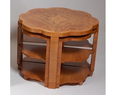 A good Art Deco figured walnut and walnut crossbanded nest of five occasional tables, the central table of circular form with