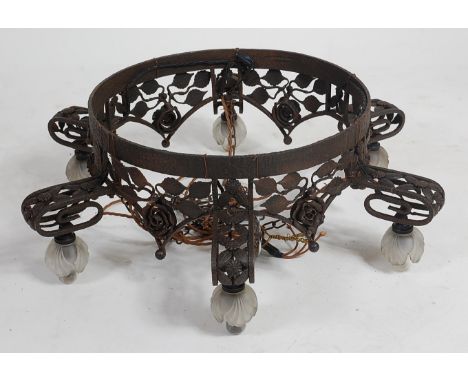 A French Art Deco wrought iron hanging six light ceiling pendant, of all-over floral cast and pierced form, with squat froste