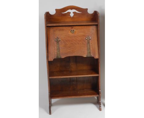 An Art Nouveau oak students bureau, the raised back having pierced cut-out motifs over typical fallfront, with shaped gilt br
