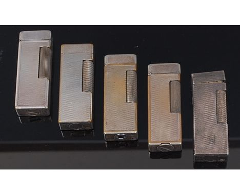 Five 1950s Dunhill silver plated engine turned pocket lighters, each with hinged covers, patent numbers; 24163, 126982, 21021