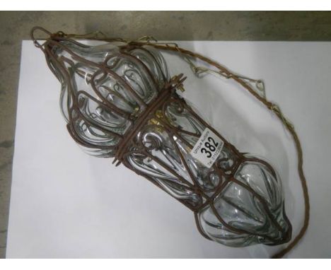 A hanging glass and metal hall light.