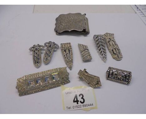 A quantity of paste clips and brooches, art deco in white metal, one stamped 'Kutiklip, ten in total.