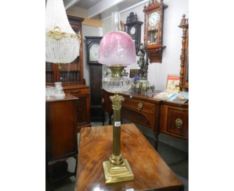 A brass Corinthian column oil lamp with original shade. COLLECT ONLY.Both clips are on collar, no drill holes, no cracks to f