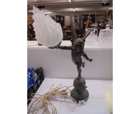 A table lamp on marble base featuring an cherub on a globe complete with flame shade, COLLECT ONLY.Some corrosion to surface,