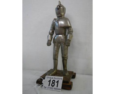 A mid 20th century table lighter in the form of a standing knight.