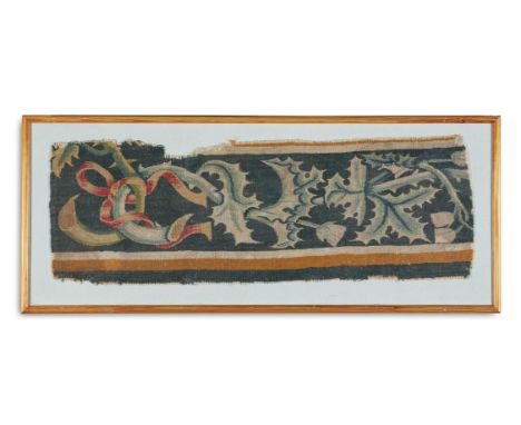 A TAPESTRY BORDER FRAGMENT WITH THISTLES AND RIBBONS  PROBABLY 17TH CENTURY  Now framed and glazed  tapestry 78 x 26.5cm at t