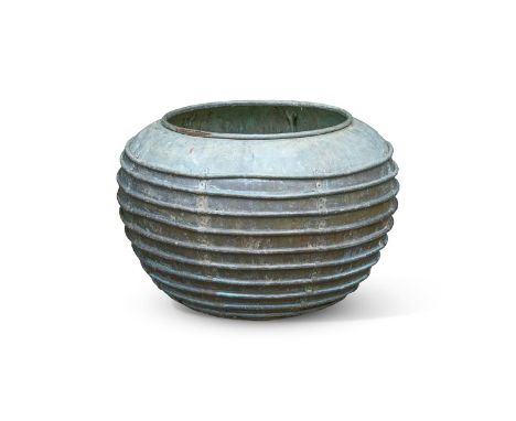 A LARGE RIBBED COPPER PLANTER  CIRCA 1910  With remnants of former stand to base  74.5cm high, 101cm diameter    Condition Re