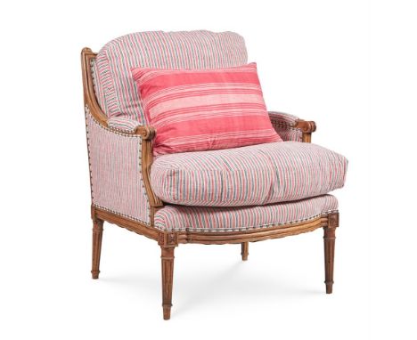 A LOUIS XVI WALNUT BERGERE  LATE 18TH CENTURY  Upholstered with close nailed natural, indigo and red stripe woven linen 96cm 