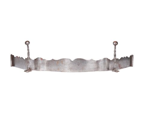 AN ARTS AND CRAFTS STEEL FENDER  ATTRIBUTED TO SIR ROBERT LORIMER, EARLY 20TH CENTURY  Of paper scroll form, with serpentine 