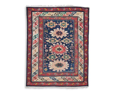 A SHIRVAN RUG  EAST CAUCASUS, LATE 19TH CENTURY  Blue ground with three main palmettes  Approximately 123cm  x 97cm  Conditio